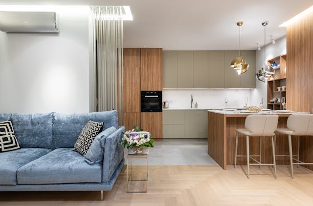 Furnished home interior showing a couch and kitchen